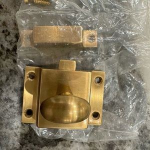 Brushed brass cabinet latch